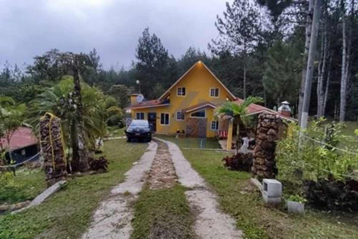 Traditional bedroom with pitched ceiling, natural decor in Cerro Azul mountain house Panama