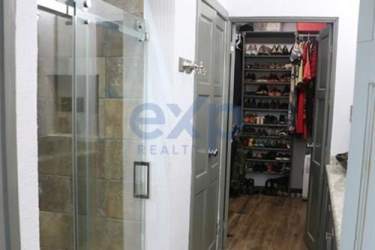 Spacious contemporary kitchen with island, stainless steel appliances and granite countertop in Chame Panama home