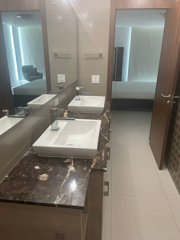 Modern master bathroom with glass enclosed shower at PH Parkside, Costa del Este, Panama