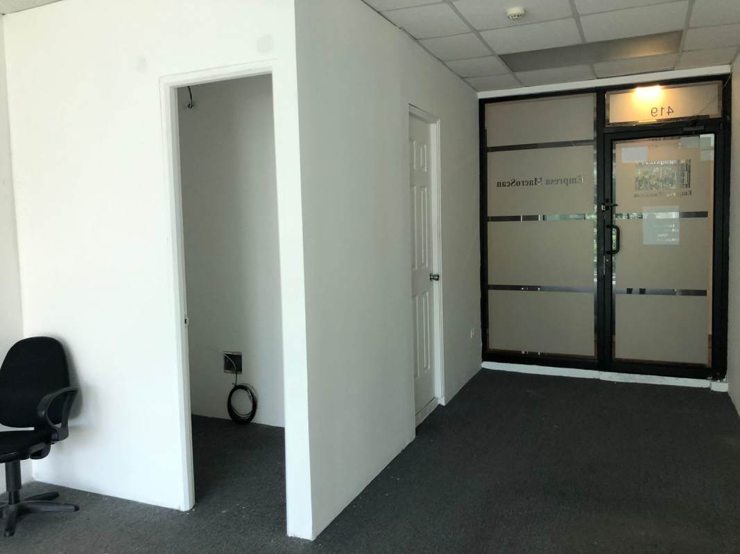 Glass door entrance and reception area in small office at The Century Tower Panama