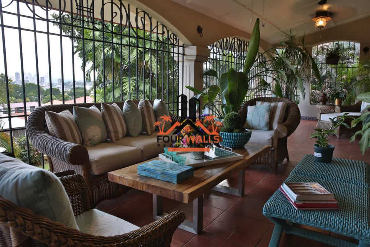 Large Mediterranean covered terrace with lounge furniture city view Panama