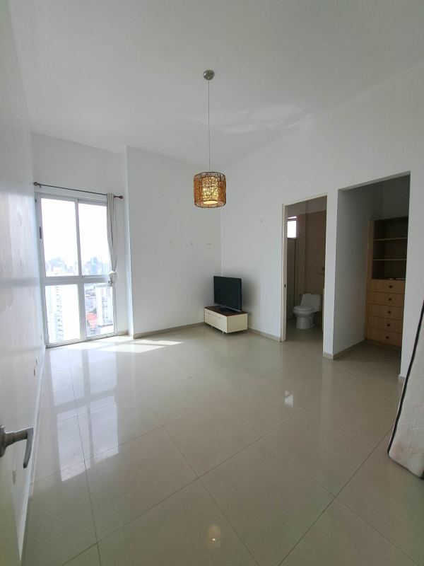 Gourmet kitchen with granite island, wood cabinetry, and tile backsplash in luxury apartment Panama