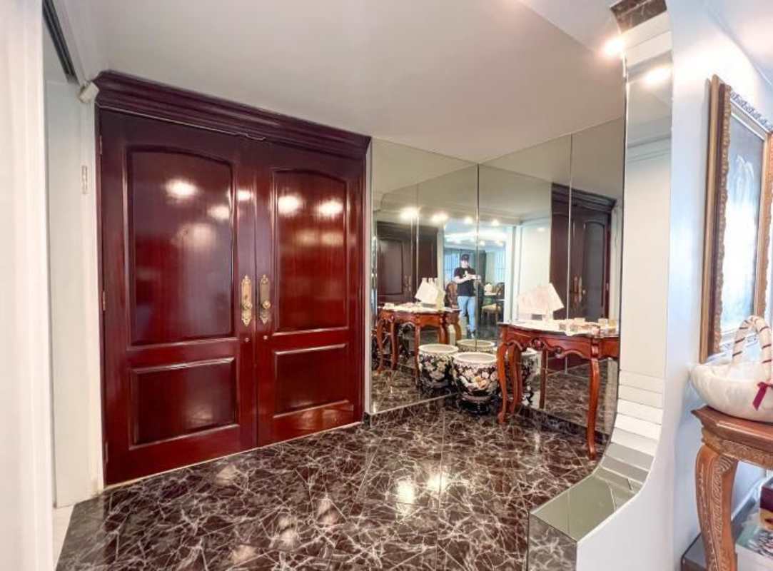 Elegant entry foyer marble floor mirrored panels Obarrio Panama apartment