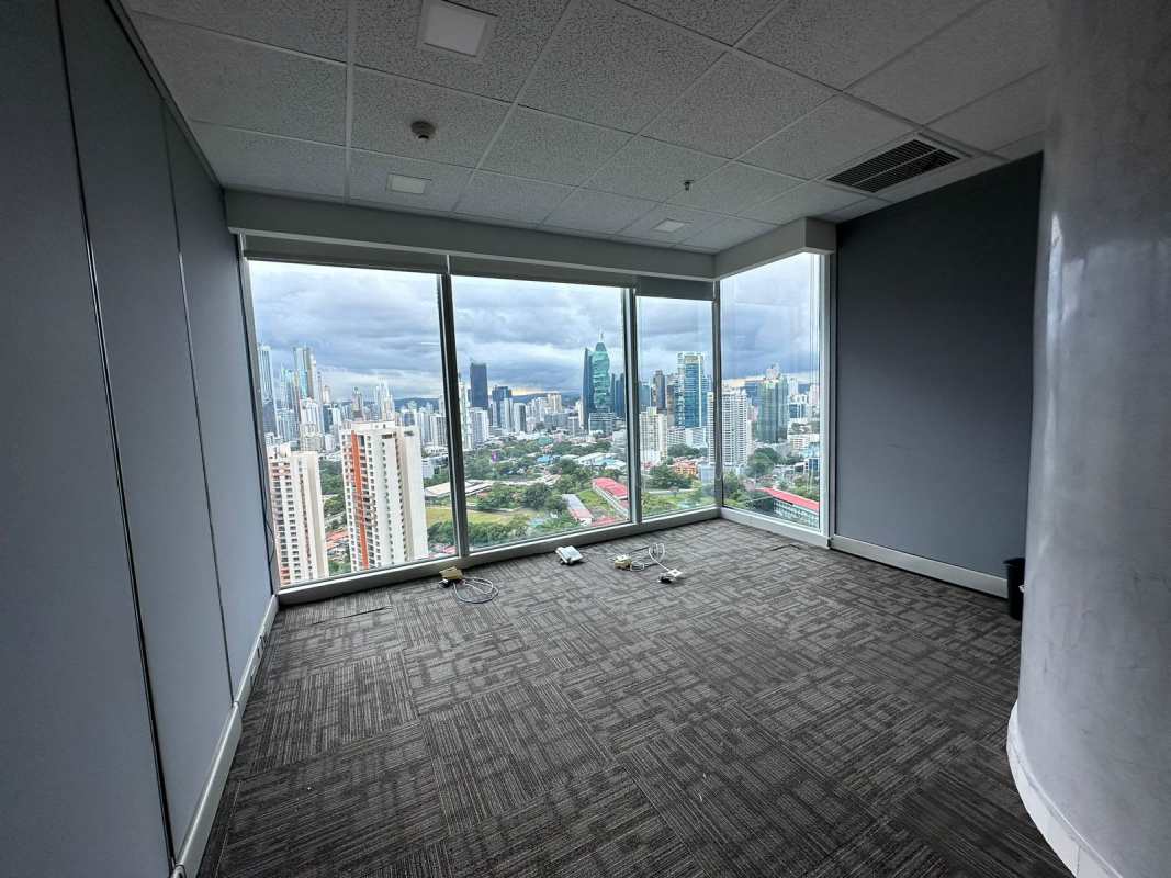 Modern office conference room with large window overlooking Panama skyline in Torre Oceanía
