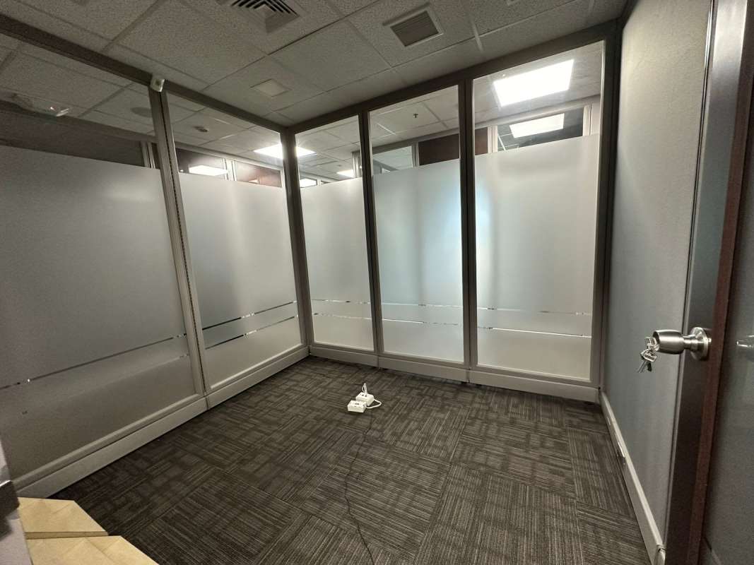 Office workspace with large window and city skyline views Torre Oceanía Panama