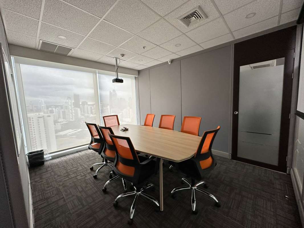 Bright private office with gray carpet and large window city view in Torre Oceanía Panama City
