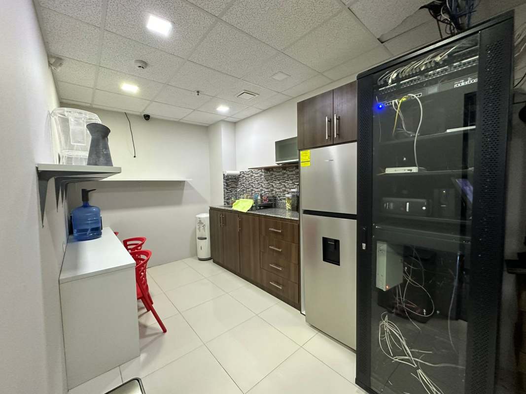 Reception lounge area with sofa, coffee tables, panoramic windows at Torre Oceanía Punta Pacifica