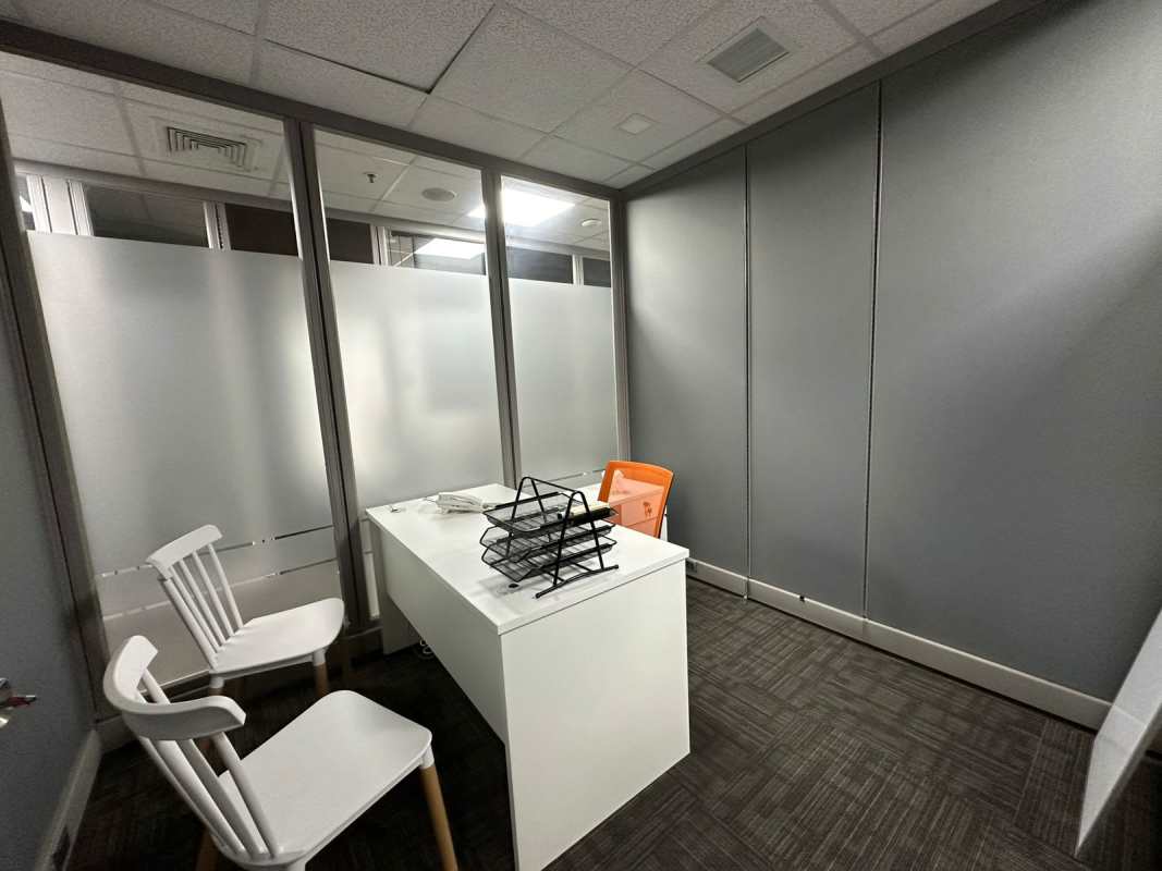 Unfurnished corner office with floor-to-ceiling windows overlooking Panama skyline Torre Oceanía