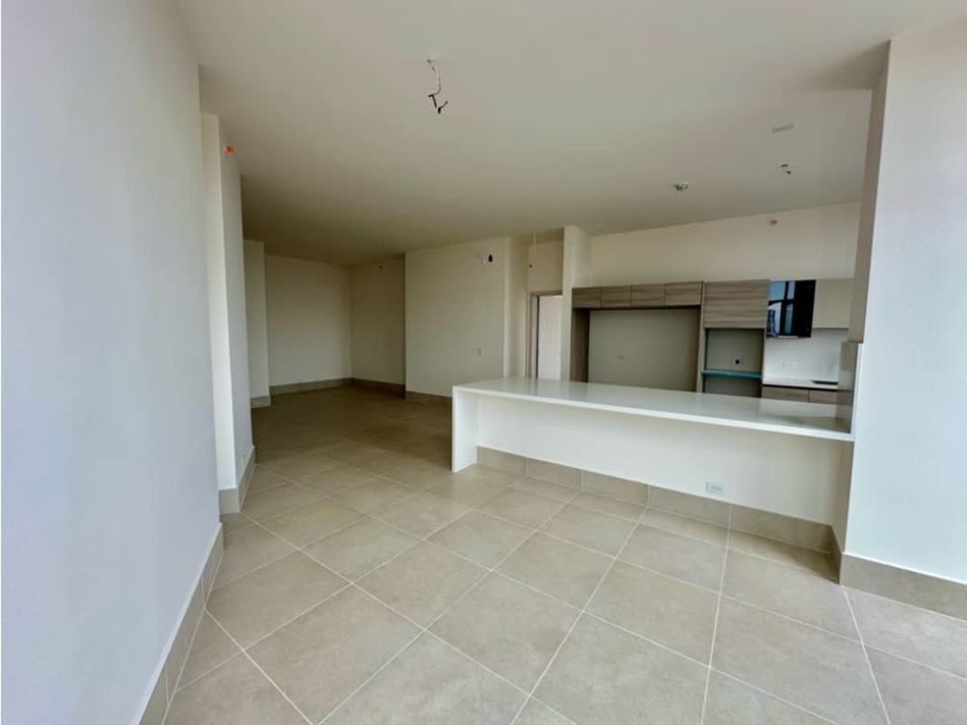 Contemporary kitchen open to light-filled living room at PH Ocean House Panama Santa Maria