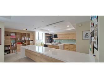 Covered patio and garden with lush plants and privacy wall in Nativa Panama Pacifico residence