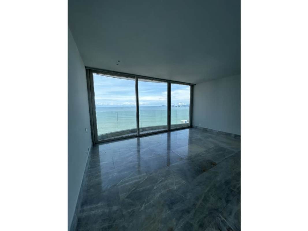 Spacious dining and living room with marble flooring and oceanfront balcony in PH The Towers Panama