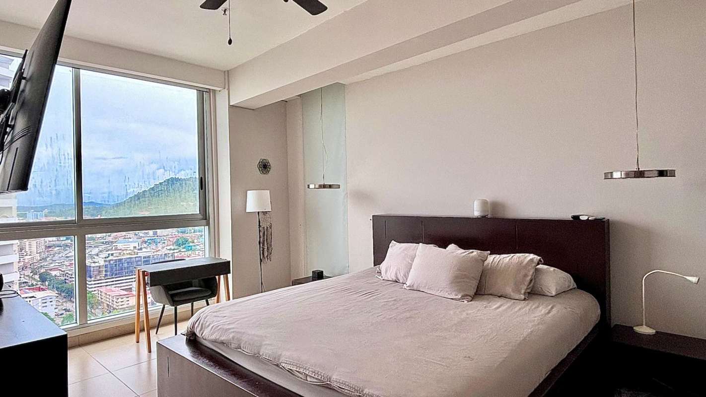 Luxury master bedroom with panoramic waterfront view, inverter AC, and built-in closets in PH Rivage Panama City