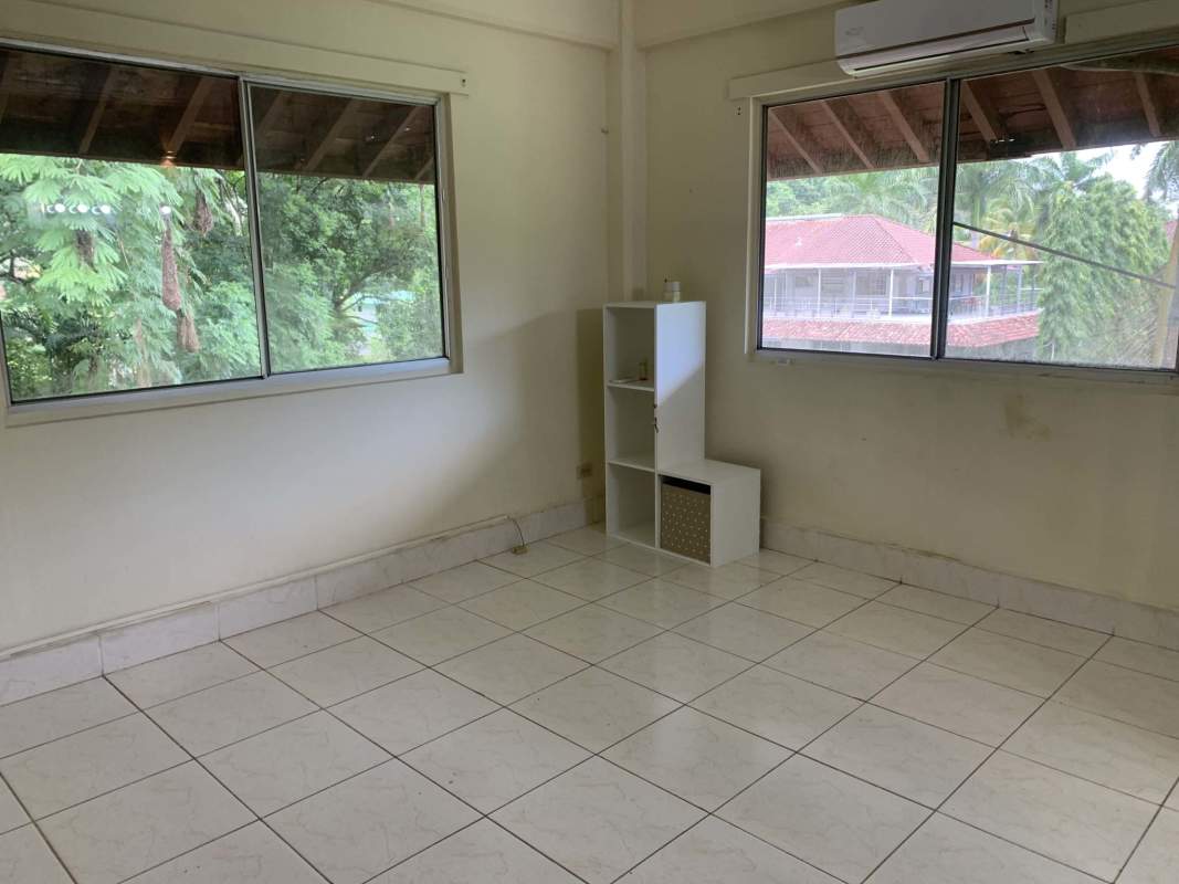 Minimal nursery with crib large window natural light cream walls clayton panama rental