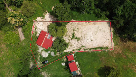Outlined rural land with buildings inside and green vegetation surrounding in San Carlos Panama