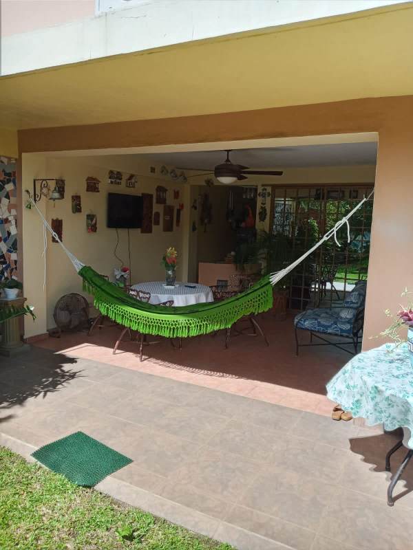 Covered outdoor patio with hammock dining ceiling fan Altos de Panama house