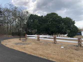 Outdoor professional tennis court surrounded by trees at Hacienda Pacífica gated community Panama
