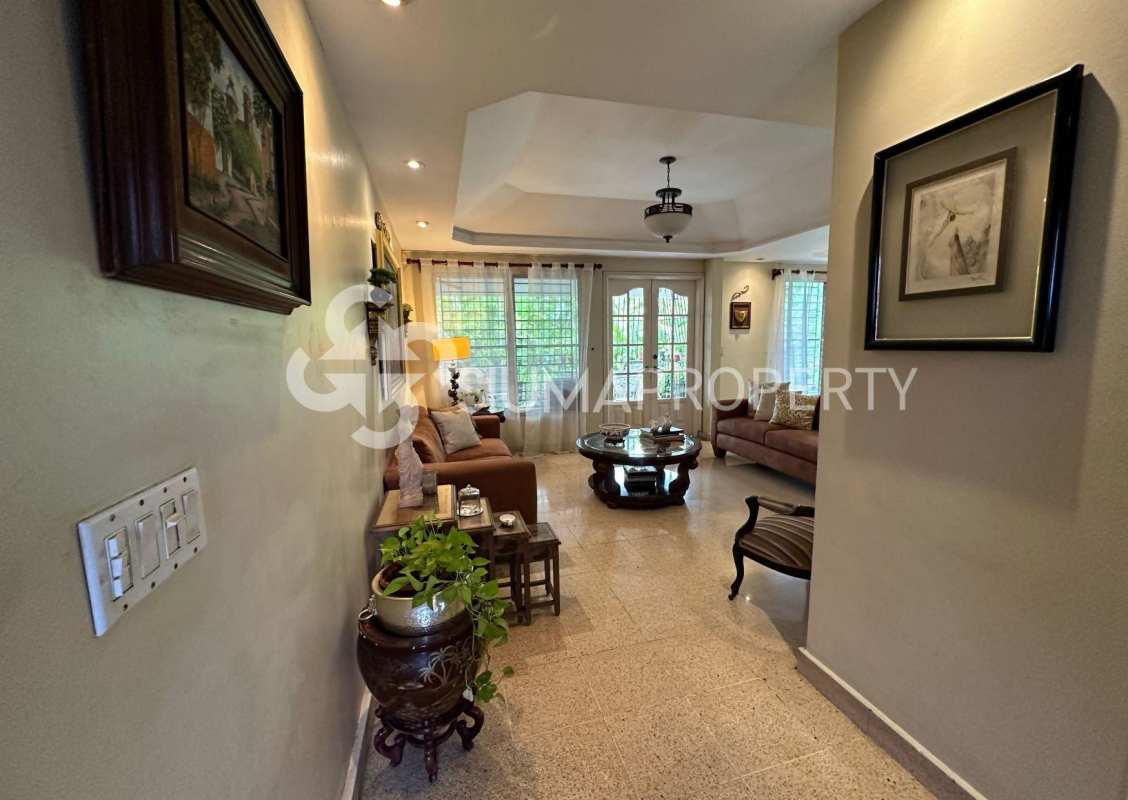 Bright living area with sofas, large windows and tile floors Villa Lilia Panama