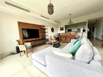 Bright open concept living room with large windows in Laguna Buenaventura beach apartment Panama