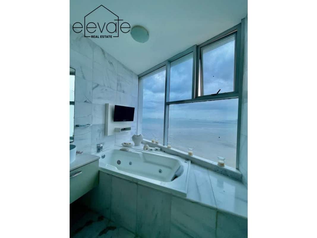 Luxurious bathroom with marble finishes, double vanity, and glass shower at Costa del Este Panama