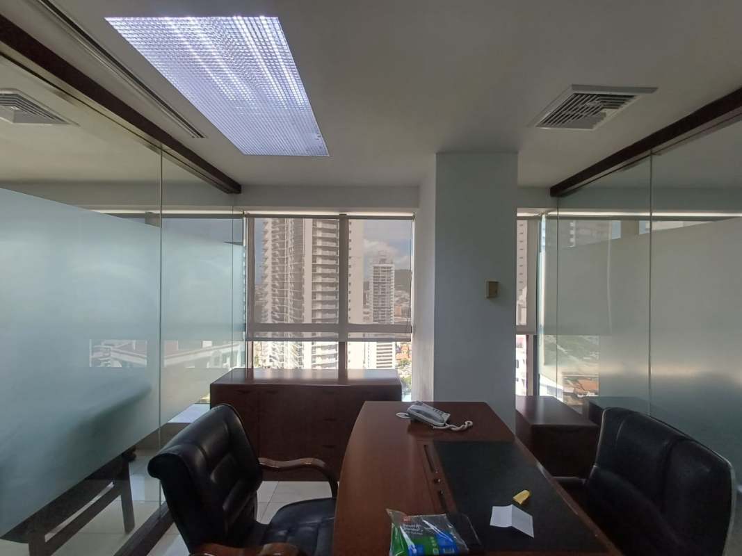 Private workspace with glass wall facing Panama City skyline Torre Exterior BAC