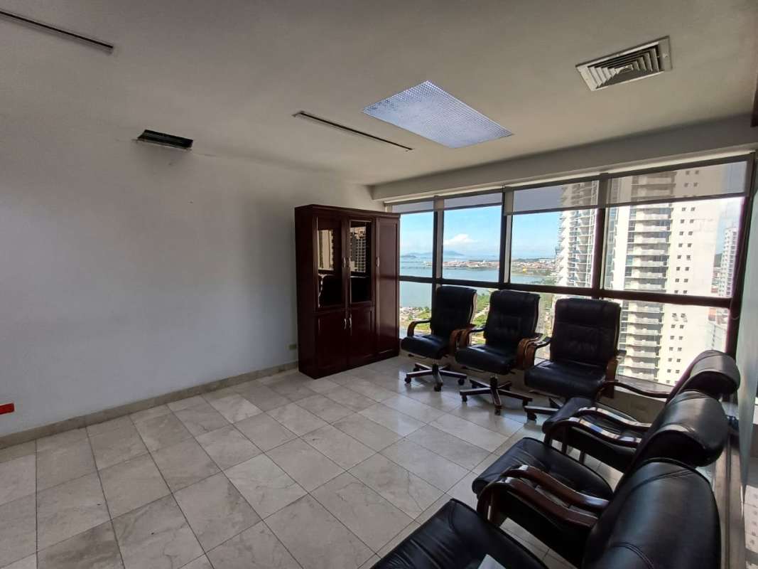 Open plan office areas with glass enclosures and ceramic floors