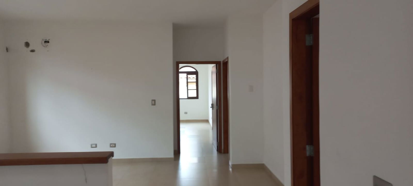 Spacious kitchen with granite countertops, wood cabinetry and tile backsplash in El Doral Costa Sur Panama