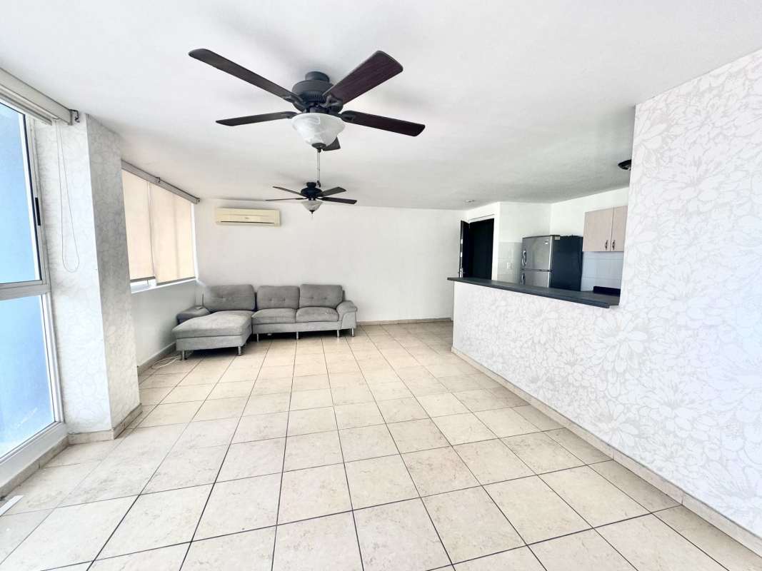 Open-concept living room with ceiling fans, tiled floor, balcony access PH Rim Tower Hato Pintado Panama