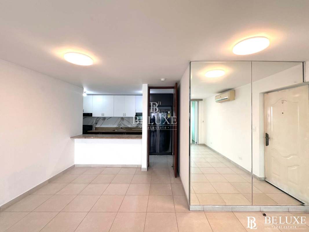 Modern kitchen with granite countertop breakfast bar white cabinetry PH Terramar San Francisco Panama