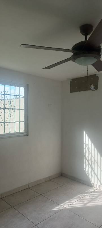 Spacious kitchen with tiled wall, double sink, window with security bars, Residencial Limajo Panama