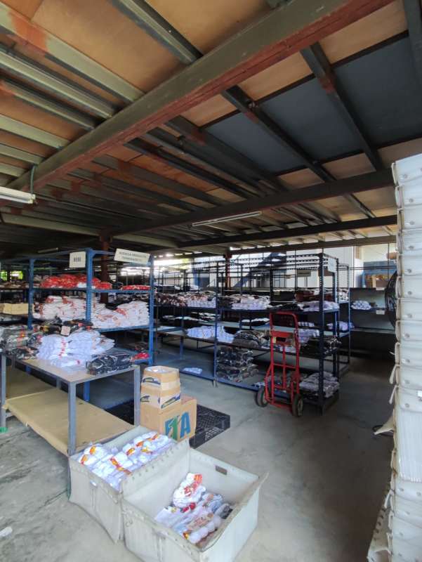 Interior warehouse organized metal shelving clothing and boxes Panama commercial property