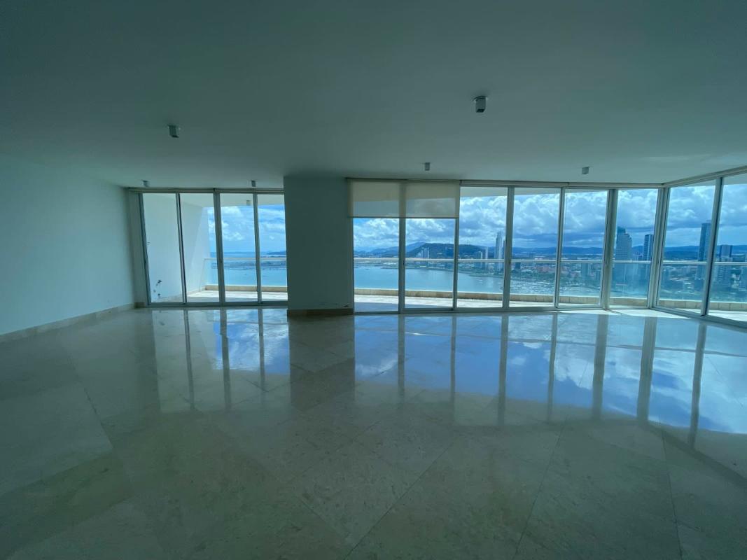 Modern kitchen with wood cabinets, black granite counters, large island, city skyline view The Point Punta Paitilla Panama