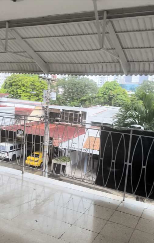 Covered balcony with metal railing overlooking urban street in Obarrio Panama City