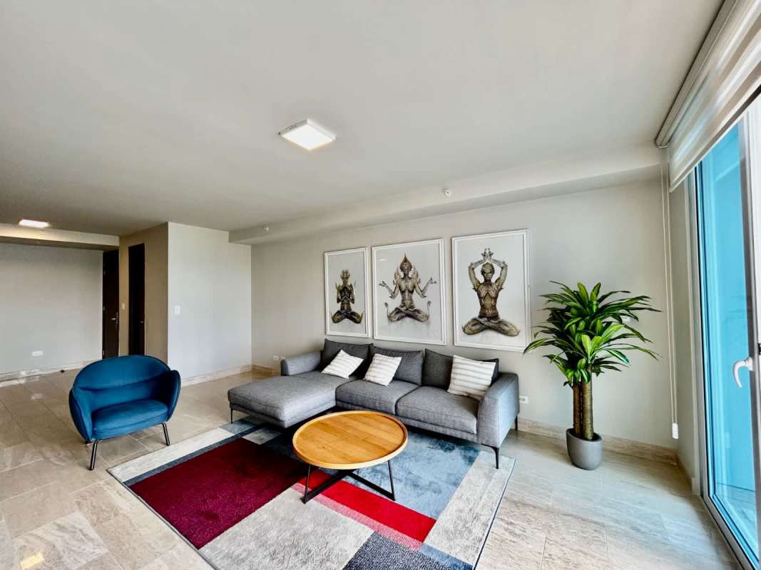 Bright open dining and living room with marble flooring in The Regent Costa del Este apartment