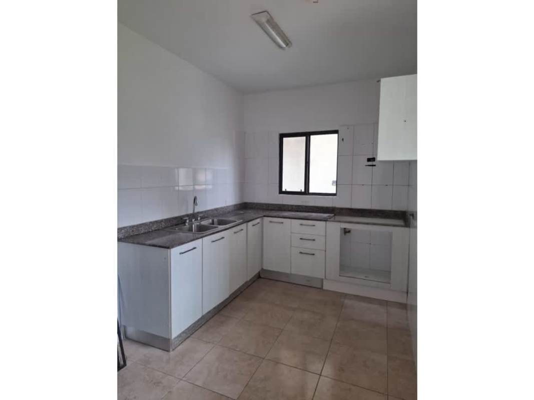 L-shaped kitchen with granite surfaces, double sink, and natural light in Las Cumbres Panama City