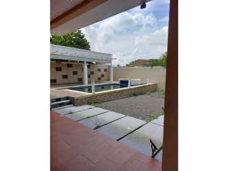 Long ceramic tiled hallway with wood ceiling and pendant light in Panama house