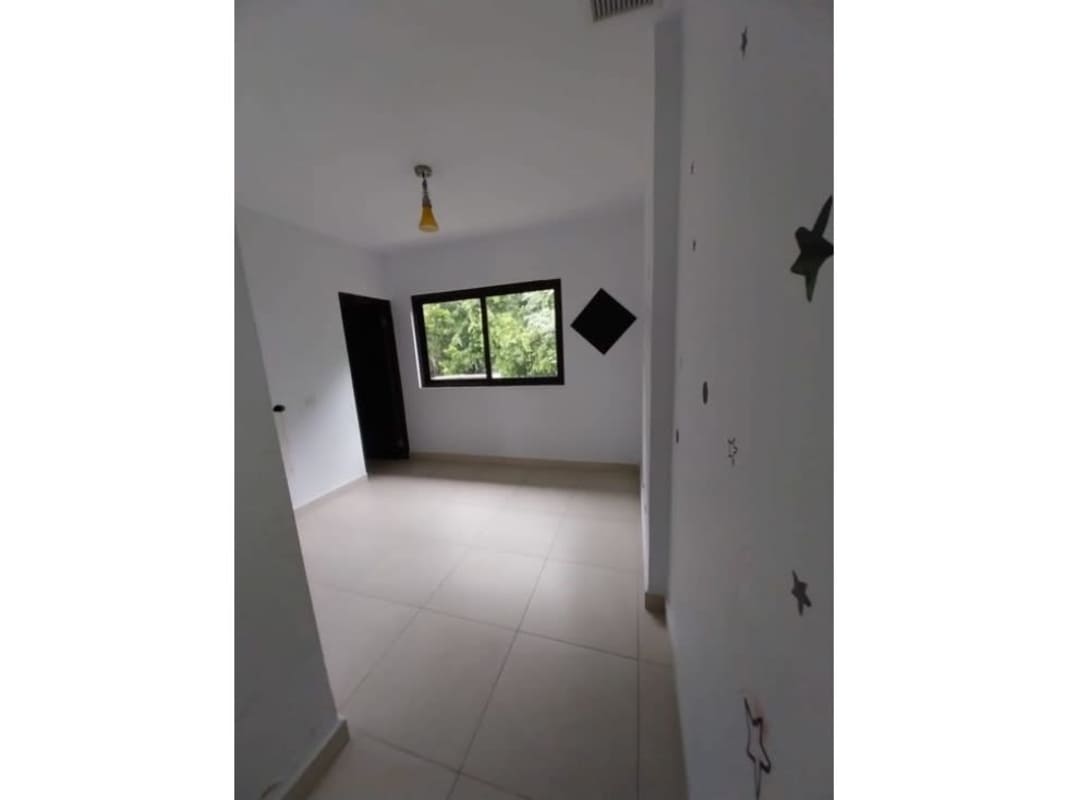 Bedroom with big window, tiled floors at Embassy Village Clayton Panama