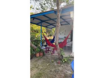 Rustic kitchen with gas stove, tiled counters, white cabinetry and blue accents in Coronado beach rental
