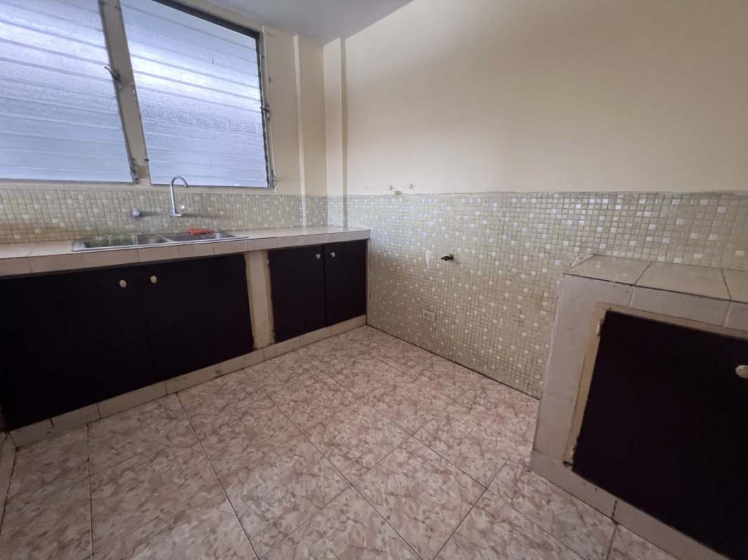 Bright basic kitchen area with tiled surfaces in Bella Vista apartment for sale Panama