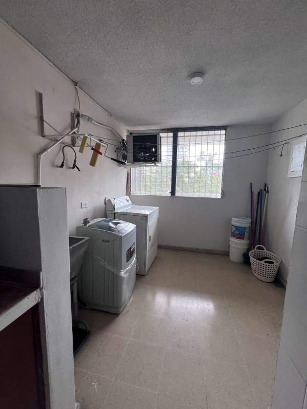 Laundry area with washer, dryer and cleaning supplies in PH Bella Vista Tower Panama
