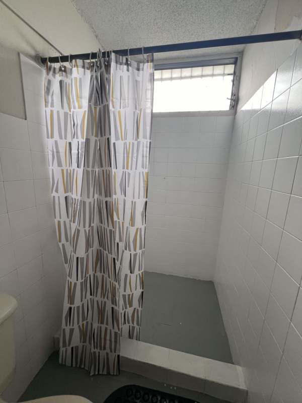 Modern bathroom with walk-in shower and white tile walls in PH Bella Vista Tower Panama