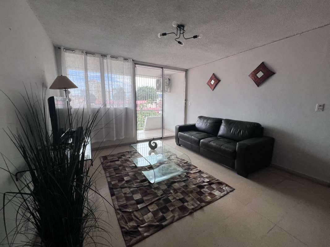 Bright living room with sofa set, glass coffee table and city views in PH Bella Vista Tower Panama