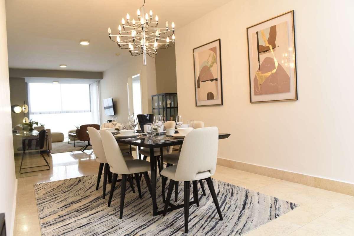 Large open-plan living room with marble floors modern furnishings PH Yoo by Starck Panama City