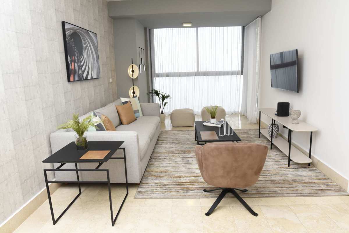 Minimalist luxury bedroom with marble floors, large window city view at PH Yoo by Starck Panama