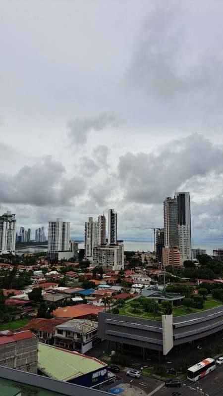 Bright bedroom with floor-to-ceiling windows city skyline view in PH Pacific Sea Panama