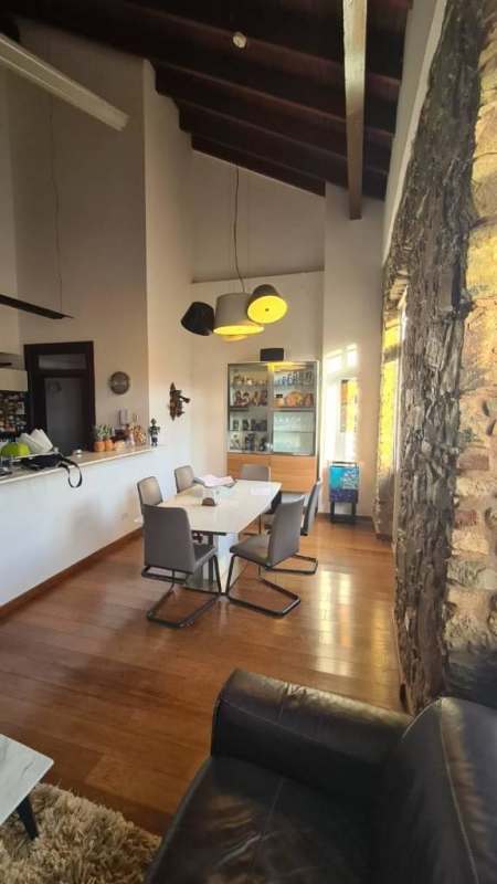 Contemporary dining with vaulted ceiling and stone wall in PH Portal de Caldas Casco Viejo Panama