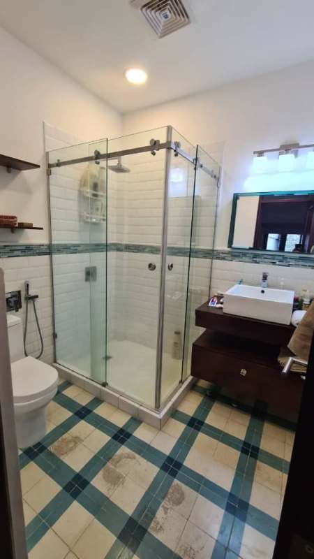 Bedroom featuring stone wall, wooden floors and AC in PH Portal de Caldas Casco Viejo Panama