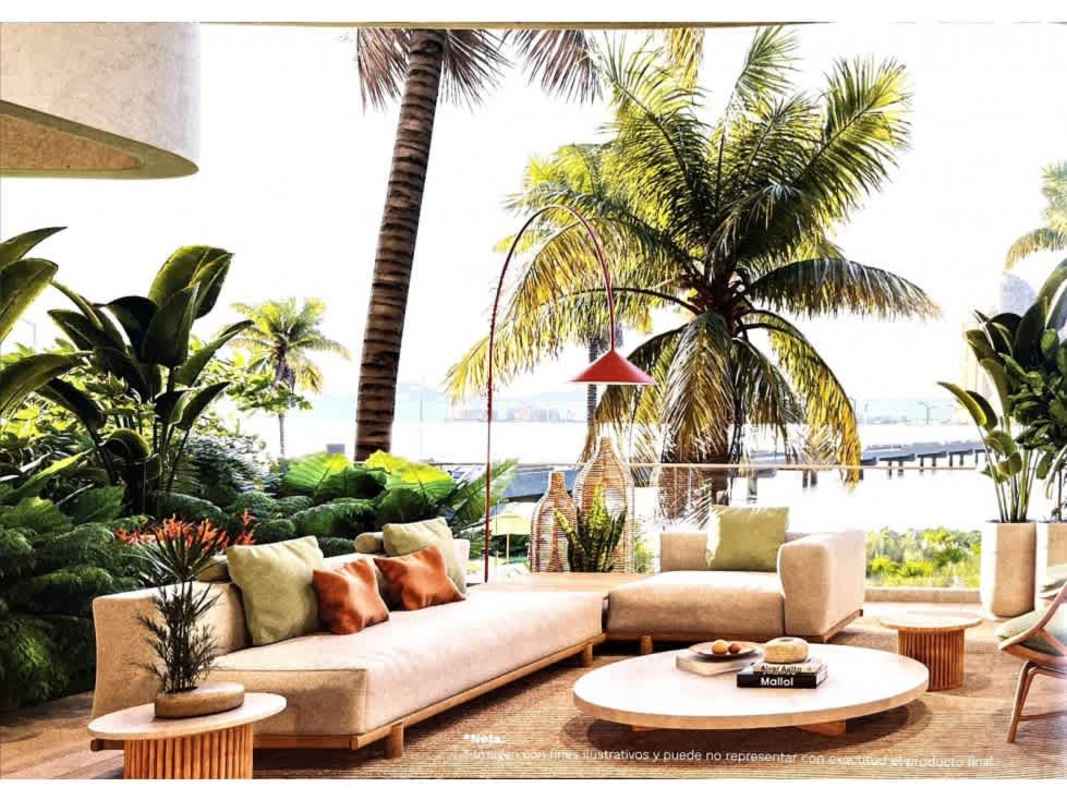 Modern outdoor patio with tropical greenery and ocean view at Ipanema Waterfront Residences Panama