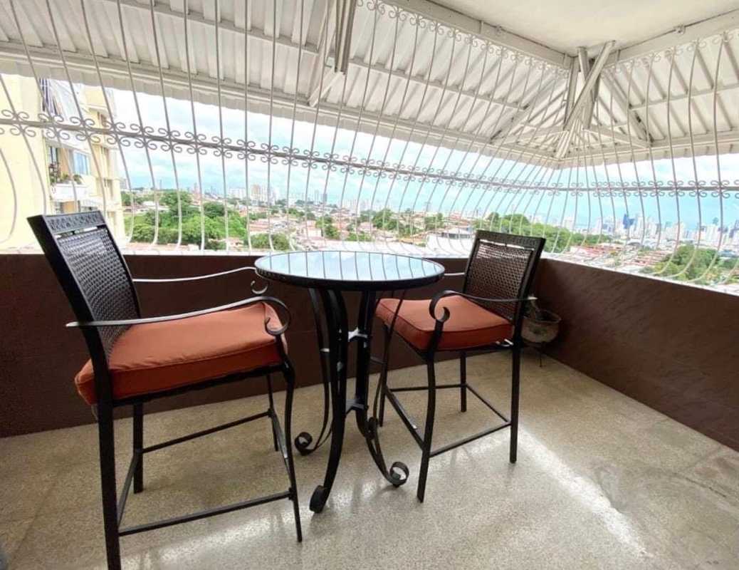 Balcony with outdoor furniture overlooking skyline at PH Neptuno apartment Panama