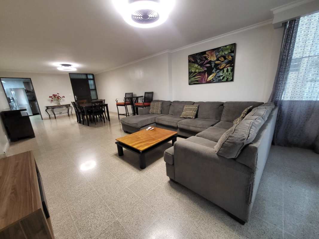 Large living dining area with sectional sofa, dining set, modern lighting in PH Neptuno Panama