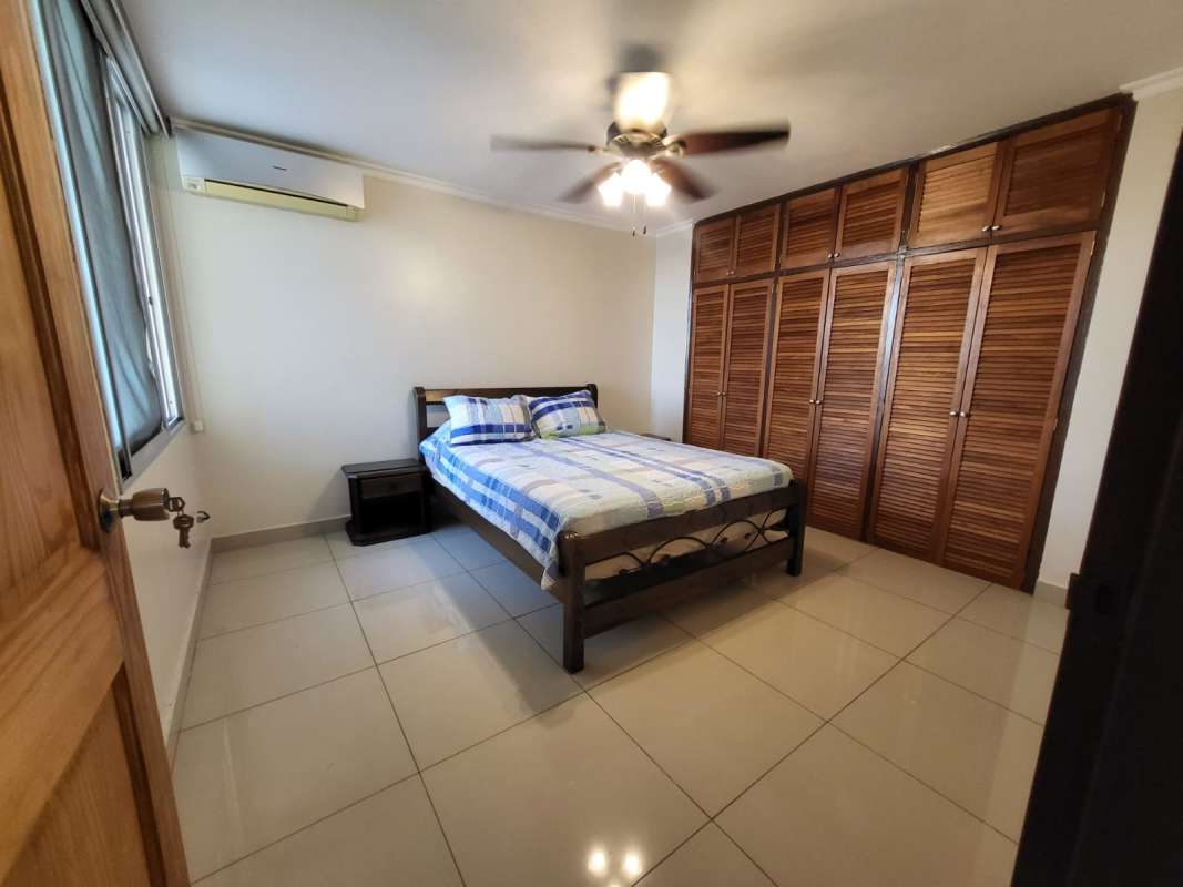 Bedroom featuring wardrobe, AC, tile flooring in PH Neptuno Panama apartment